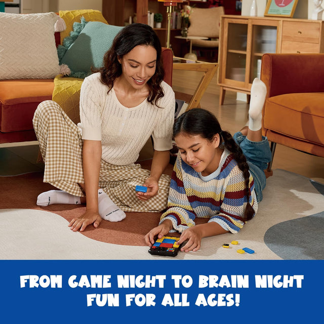 Woman and young girl playing with a colorful game on the floor in a living room.