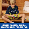 Child playing with a magnetic sliding toy in a wooden indoor setting